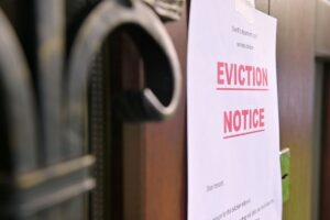 Eviction Notice hanging on a door. Zenith Properties can help landlords with How to Evict a Tenant in Washington State.