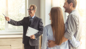 real estate pro who recently became property manager in washington shows property to couple