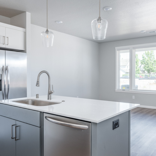 Facing towards large living room windows from kitchen at Grove 162nd.