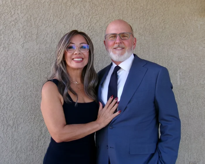 Denny and Johanna Miller standing together, owners of Zenith Properties