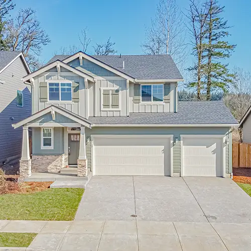 Exterior of a well-kept, two-story rental home featuring a three-car garage and manicured lawn, professionally overseen by Zenith Properties NW